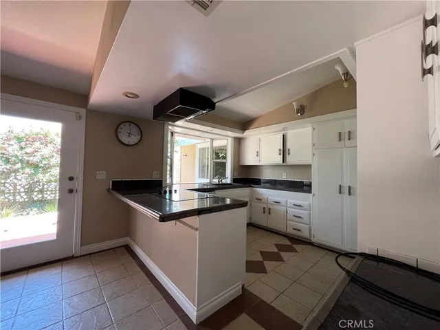 a kitchen with granite countertop a sink and cabinets