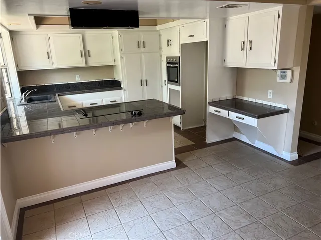 a kitchen with stainless steel appliances a stove a refrigerator and a cabinets