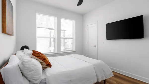 a bedroom with a bed and a flat screen tv