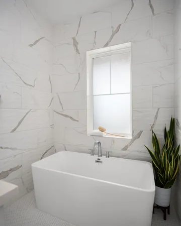 a white bath tub sitting next to a white sink