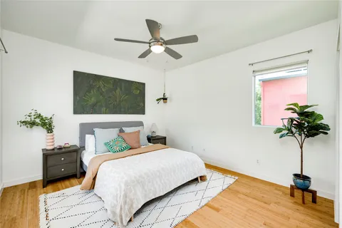 a bedroom with a bed and a potted plant