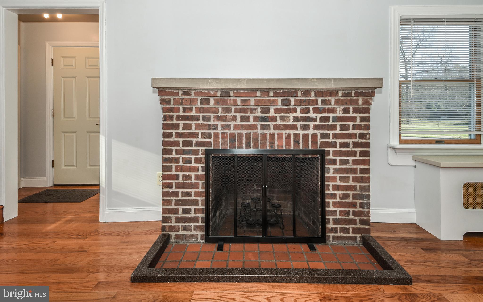 3 Erdenheim Road Glenside, PA 19038 - Photo 8 of 35 Stone mantle and brick hearth.