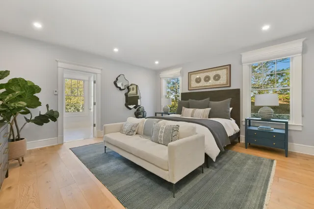 a bedroom with a large bed and a couch