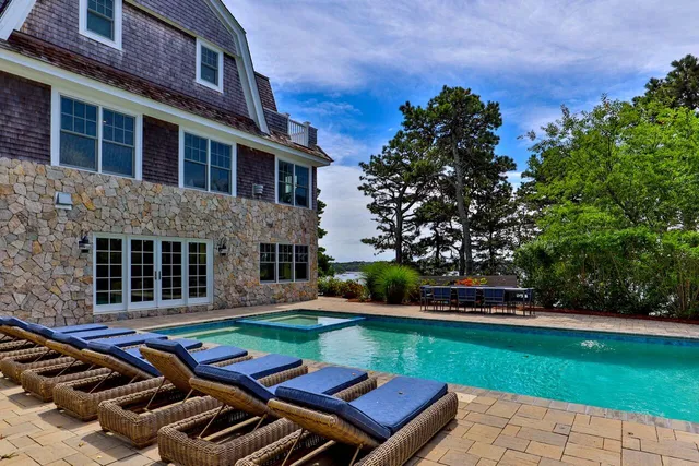front view of a house with a yard table and chairs