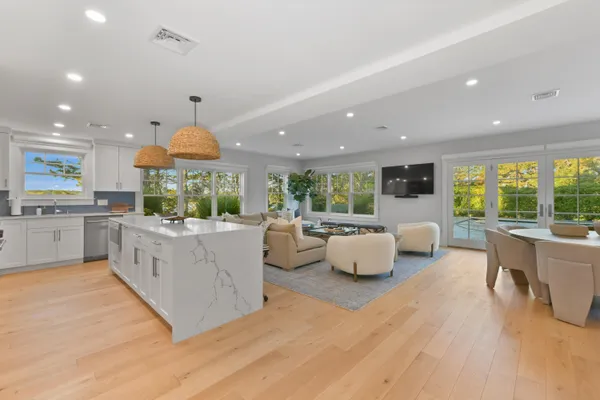 a large kitchen with kitchen island granite countertop a large counter top stainless steel appliances and couches