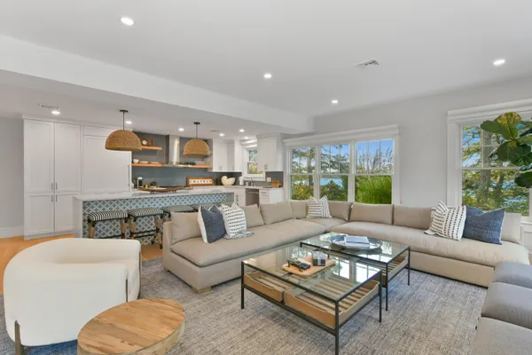 a living room with furniture kitchen and a table