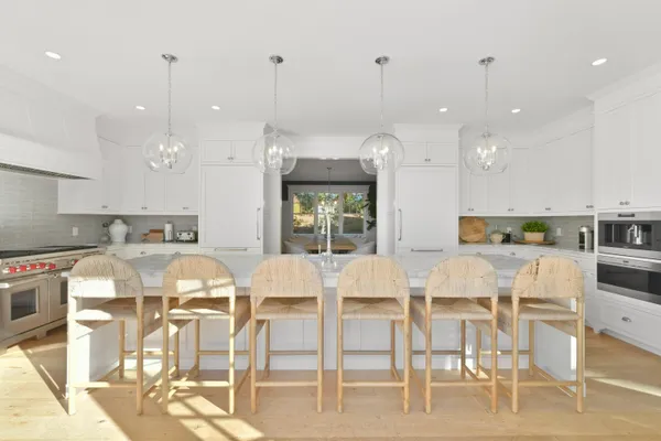 a large kitchen with a table and chairs