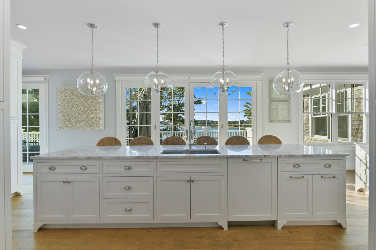 558 Fox Hill Road Chatham, MA 02633 - Photo 7 of 39 a kitchen with center island and windows