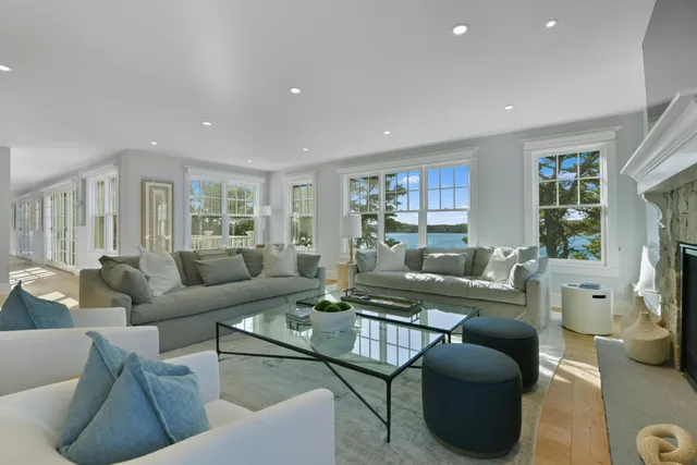 a living room with furniture fireplace and a window