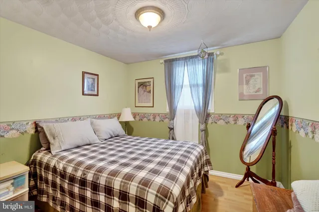 a bedroom with a bed a desk and chair