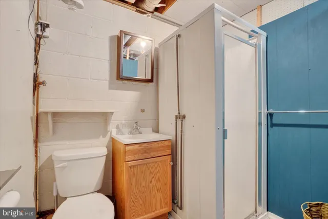a white toilet sitting next to a bathroom sink