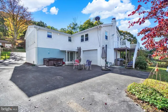 a view of a house with backyard and sitting area