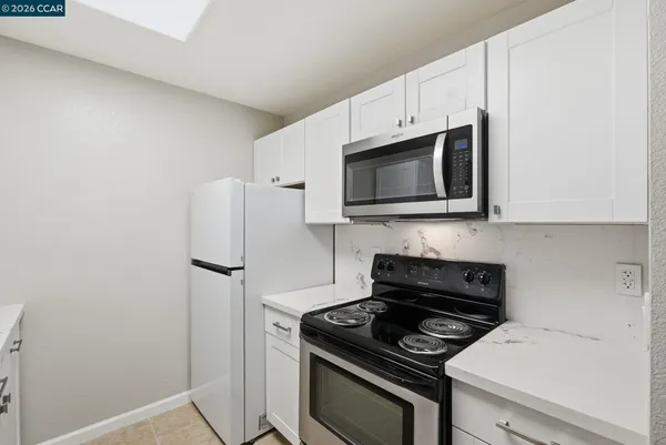 a kitchen with a stove and a microwave
