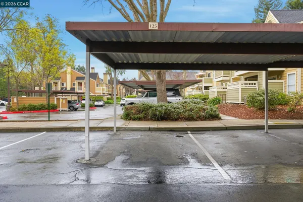 a view of a street with wooden fence