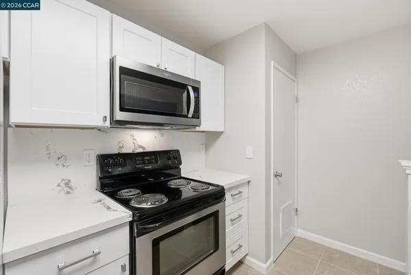 a kitchen with a stove and a microwave