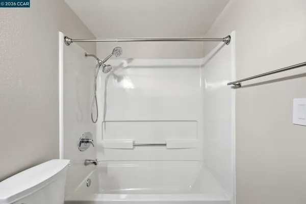 a bathroom with a shower and a toilet