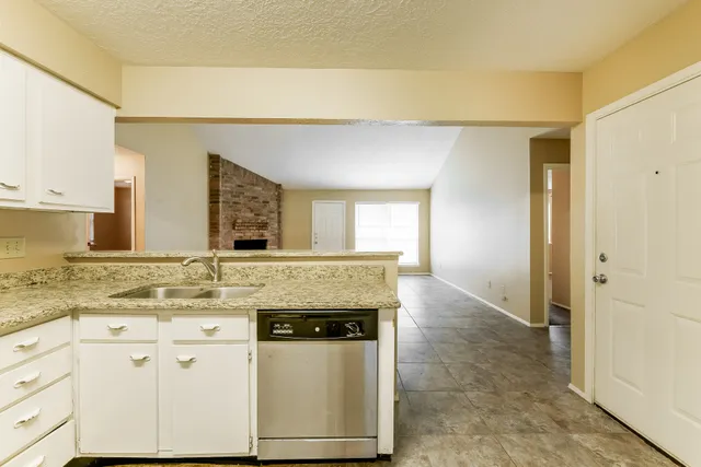 a view of a kitchen with granite countertop cabinets and a sink
