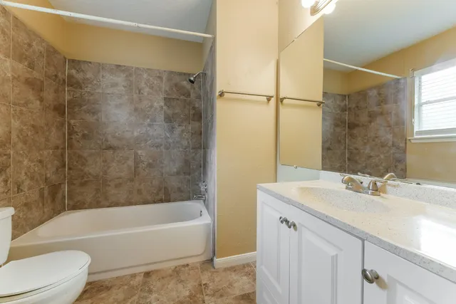 a bathroom with a sink mirror toilet and bathtub