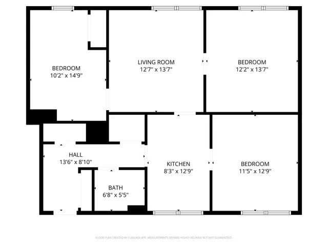 a kitchen with granite countertop a stove a sink cabinets and wooden floor