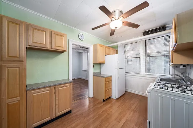 a kitchen with stainless steel appliances granite countertop a stove and a refrigerator