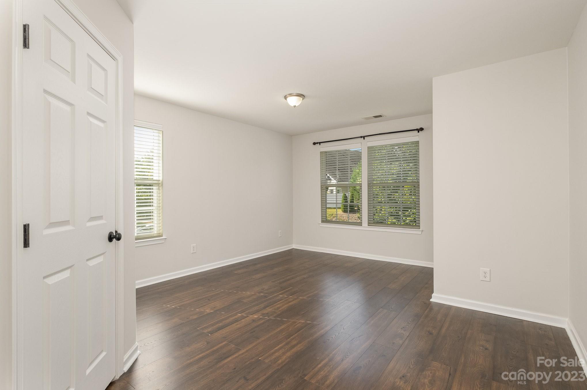 717 Prospect Lane Fort Mill, SC 29708 - Photo 16 of 21 an empty room with wooden floor and windows