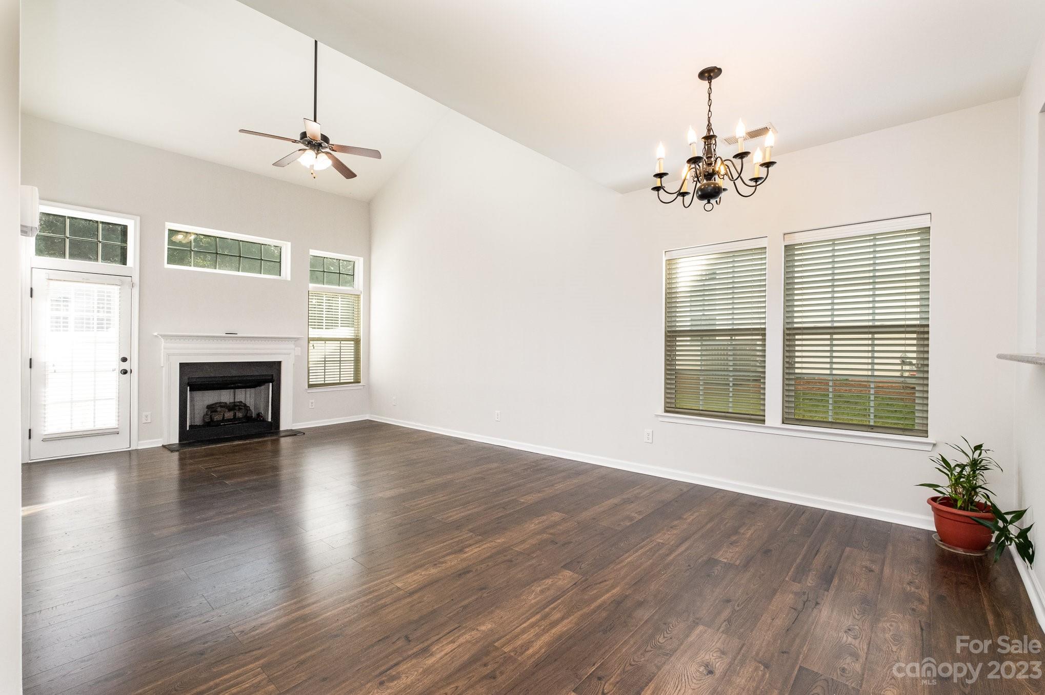 717 Prospect Lane Fort Mill, SC 29708 - Photo 3 of 21 a view of an empty room with a fireplace and wooden floor