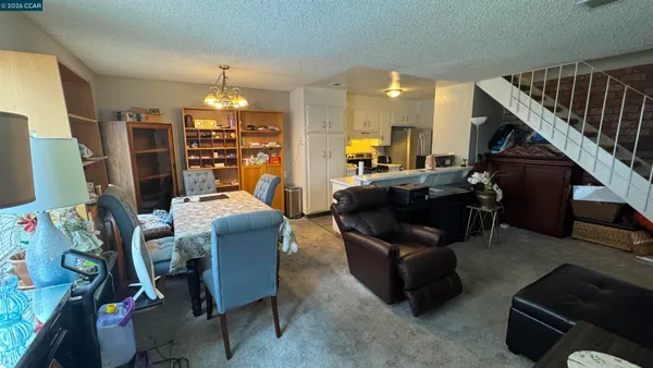 a living room with furniture and a chandelier