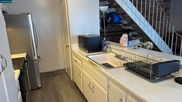 a kitchen with a refrigerator and a stove