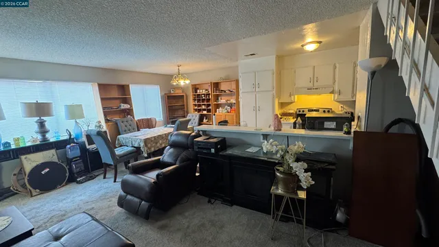 a living room with furniture and a mirror