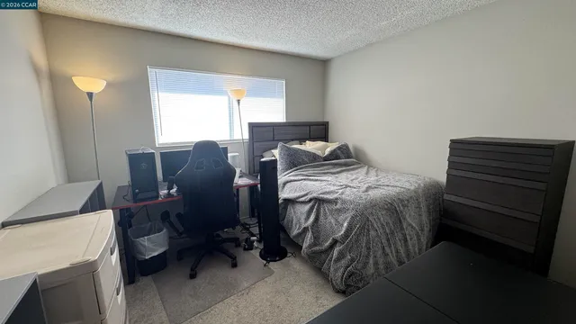 a bed sitting in a room next to a window