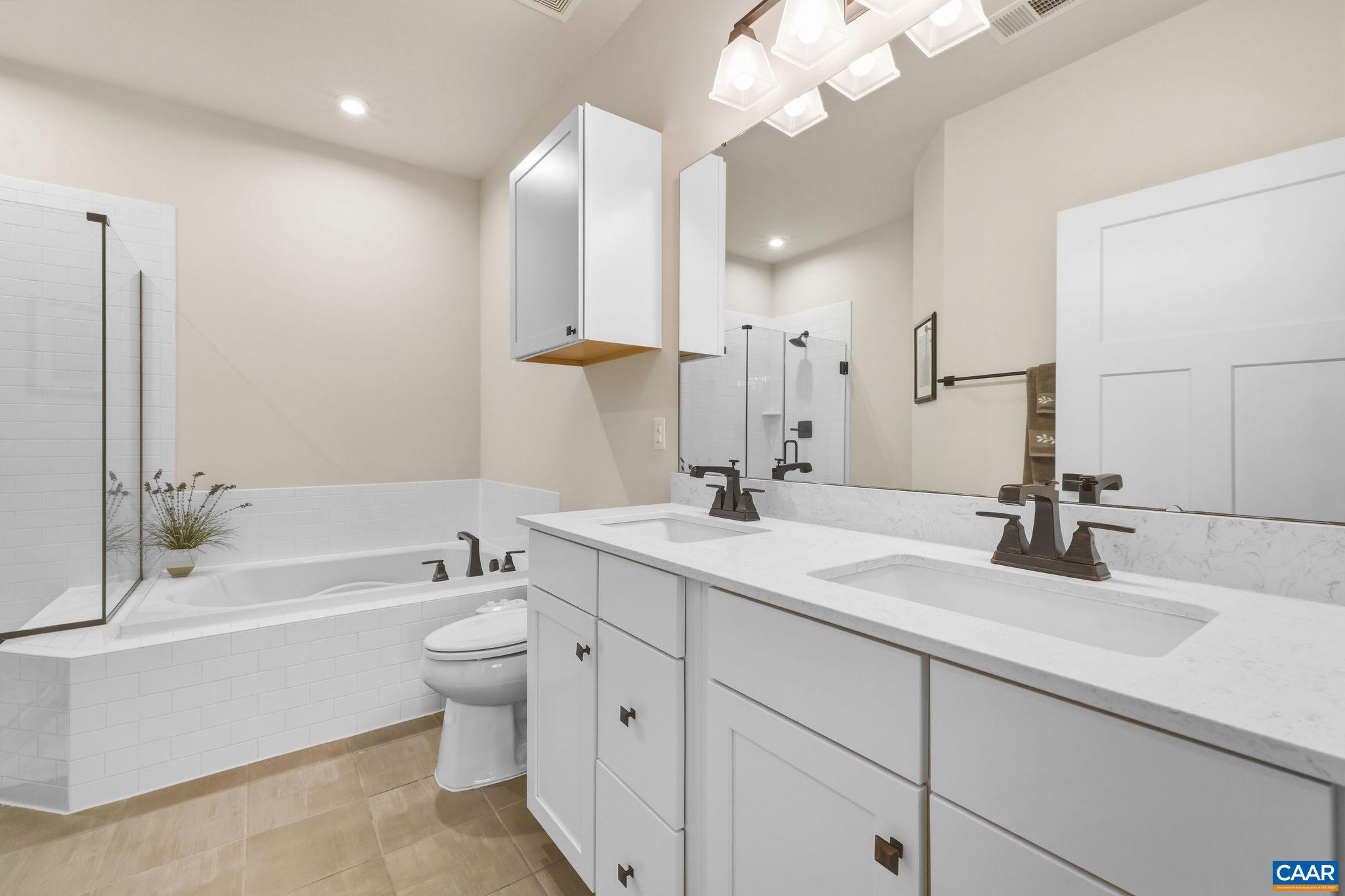 360 Winding Road Keswick, VA 22947 - Photo 30 of 48 a bathroom with a double vanity sink mirror and toilet