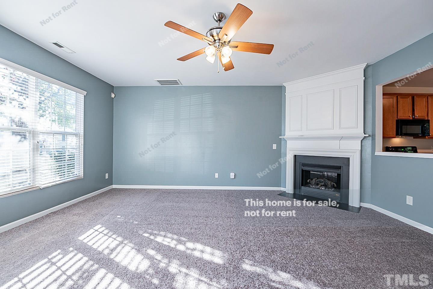 8303 Clasara Circle Raleigh, NC 27613 - Photo 3 of 17 a view of a livingroom with a fireplace and window