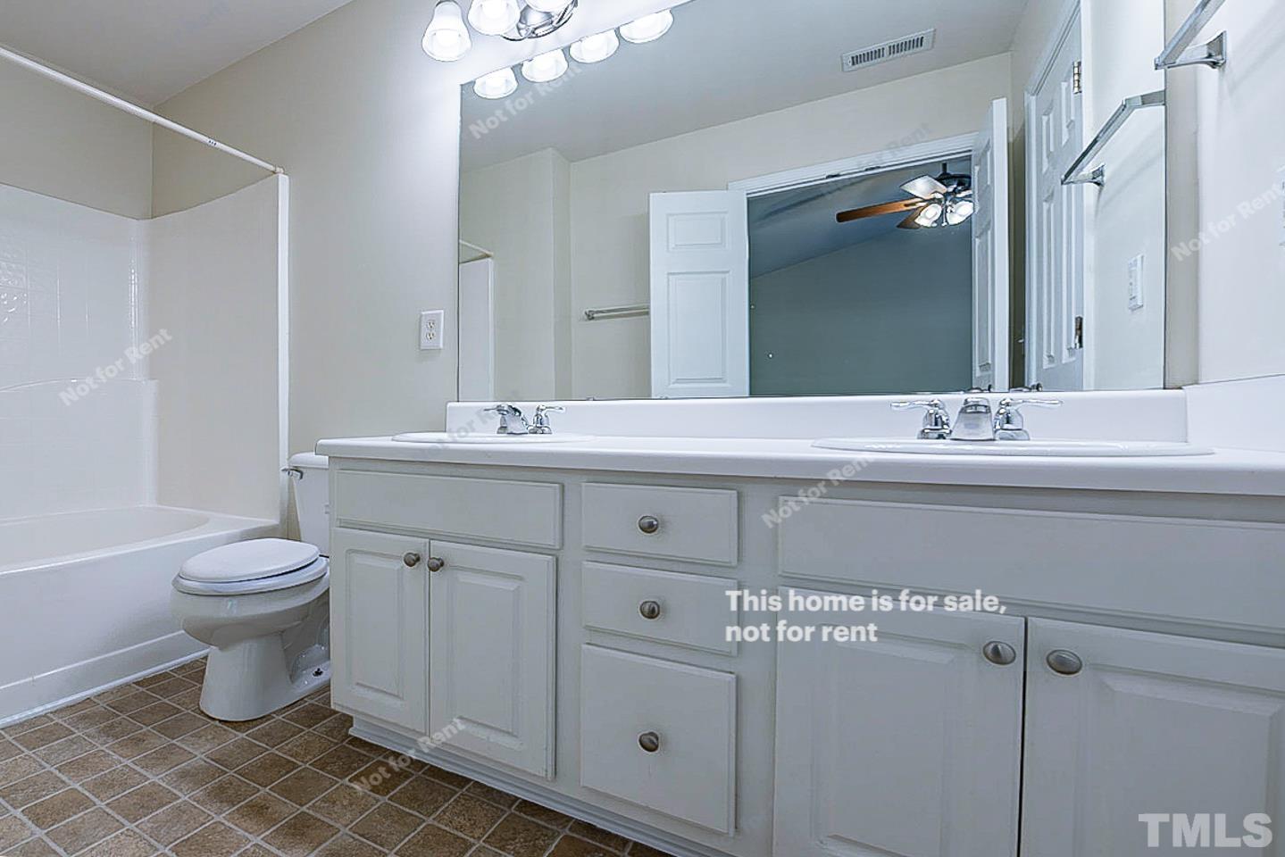 8303 Clasara Circle Raleigh, NC 27613 - Photo 4 of 17 a bathroom with a sink toilet and shower