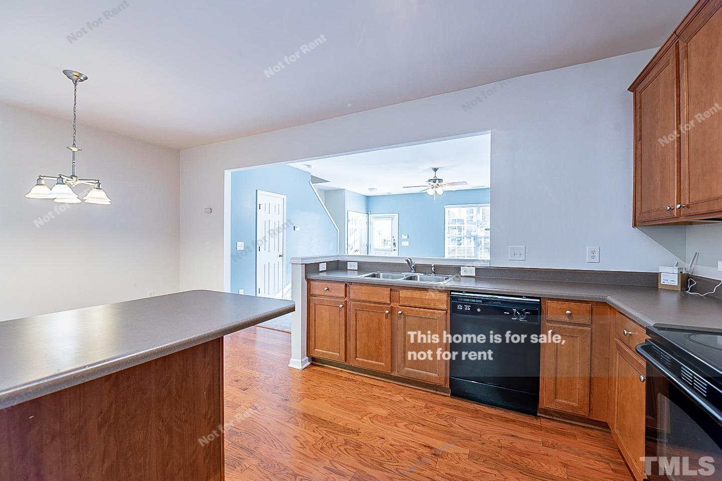 8303 Clasara Circle Raleigh, NC 27613 - Photo 8 of 17 a kitchen with stainless steel appliances granite countertop a sink a stove top oven a counter space and cabinets