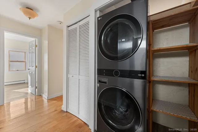 a view of a bedroom with washer and dryer