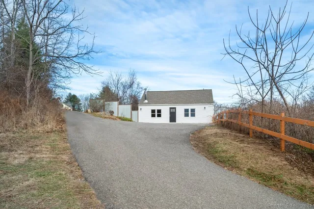 a view of a house with a yard covered in snow
