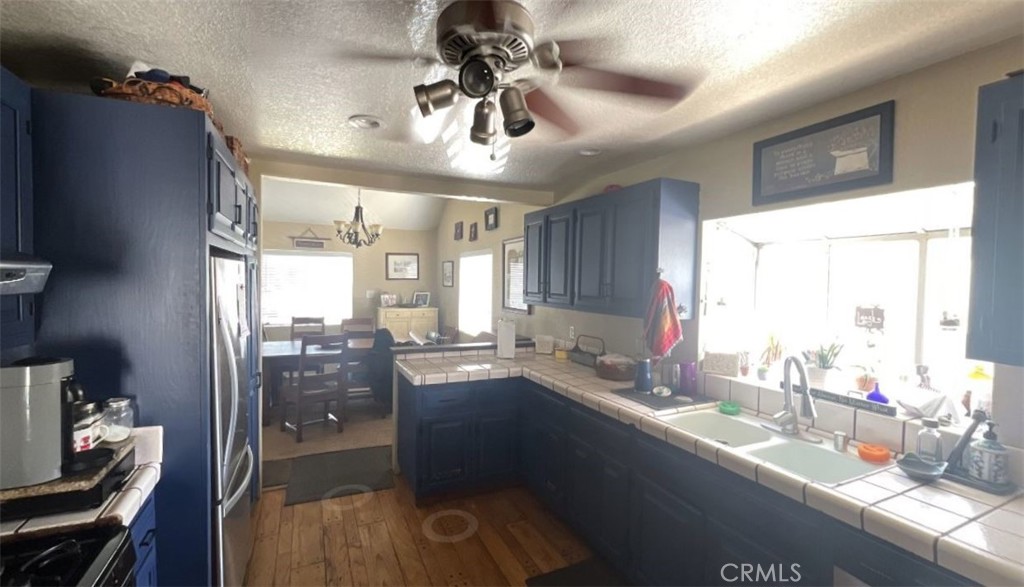 4115 East 6th Street Long Beach, CA 90814 - Photo 12 of 34 a kitchen with granite countertop a sink appliances cabinets and a counter top space