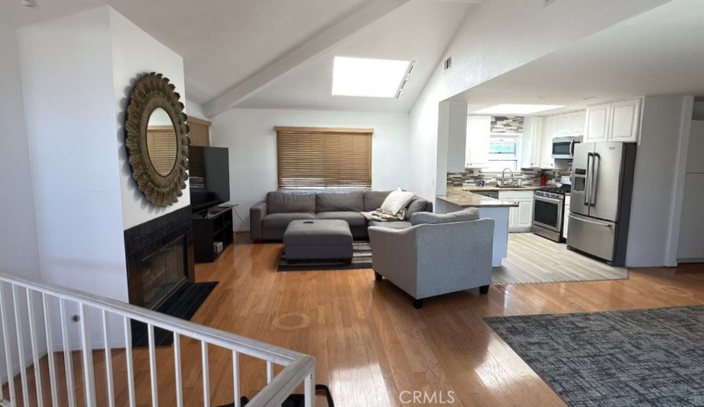 4115 East 6th Street Long Beach, CA 90814 - Photo 24 of 34 a living room with furniture and a flat screen tv