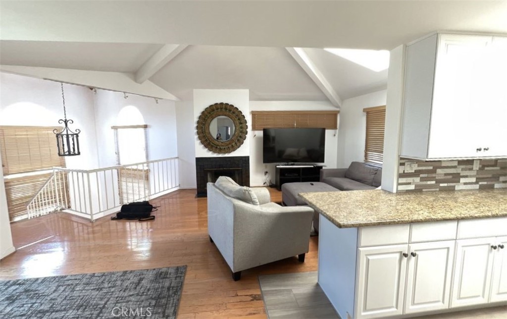 4115 East 6th Street Long Beach, CA 90814 - Photo 28 of 34 a living room with furniture and a clock