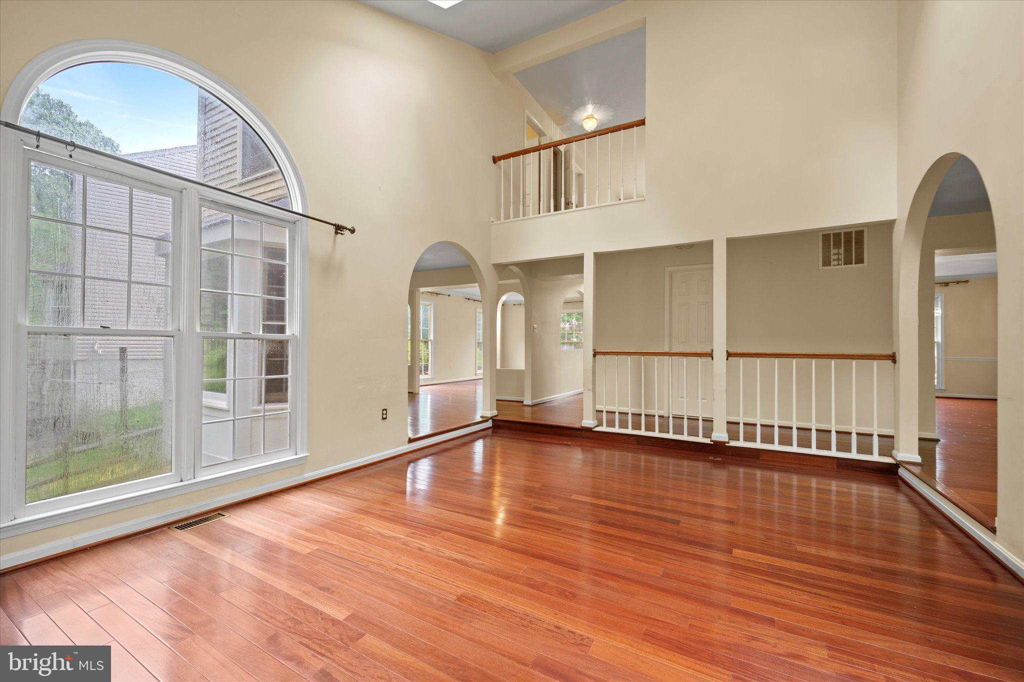 6832 Compton Heights Circle Clifton, VA 20124 - Photo 13 of 54 a view of an empty room with wooden floor and a window