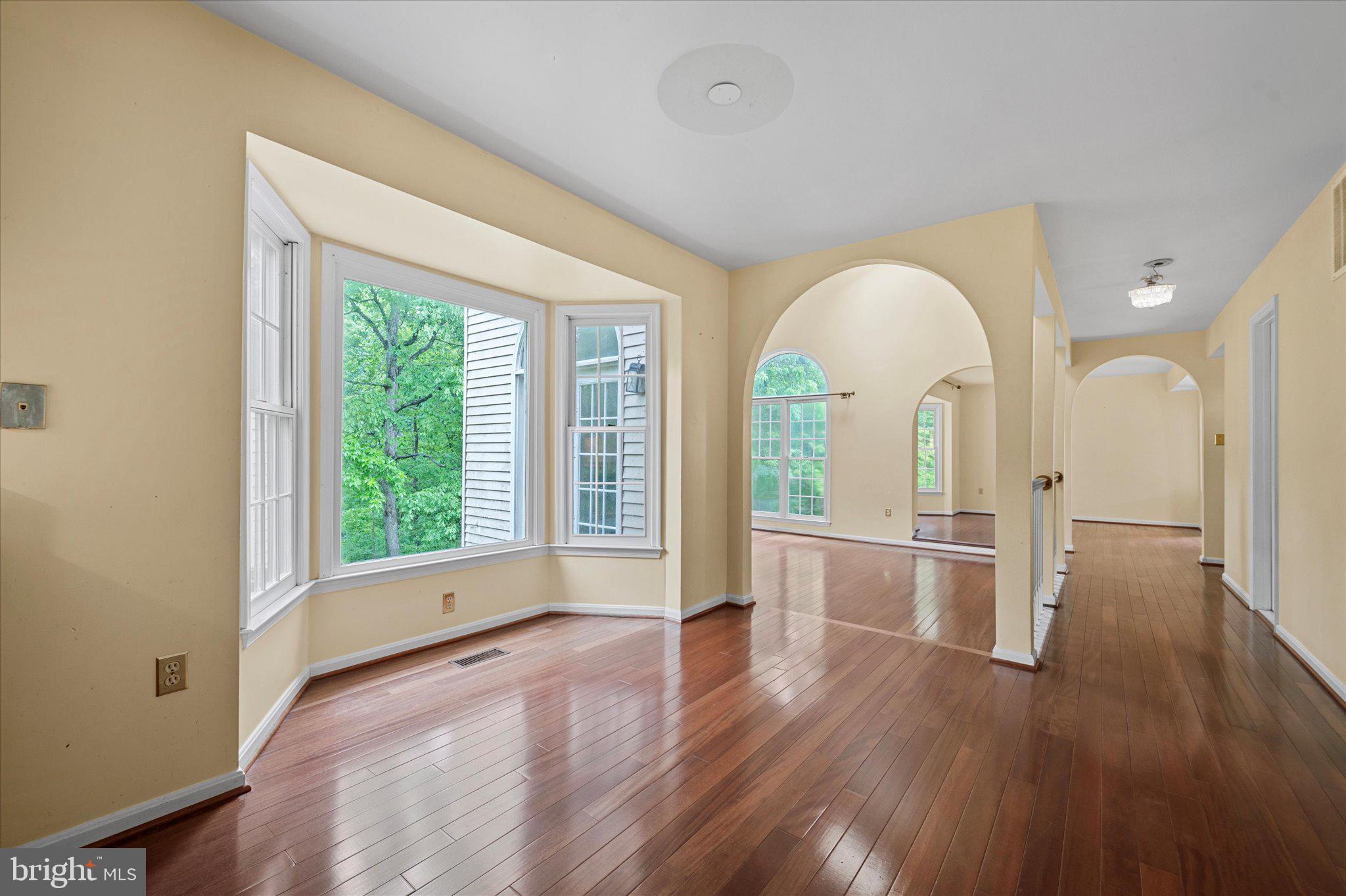 6832 Compton Heights Circle Clifton, VA 20124 - Photo 15 of 54 a view of empty room with wooden floor and fan