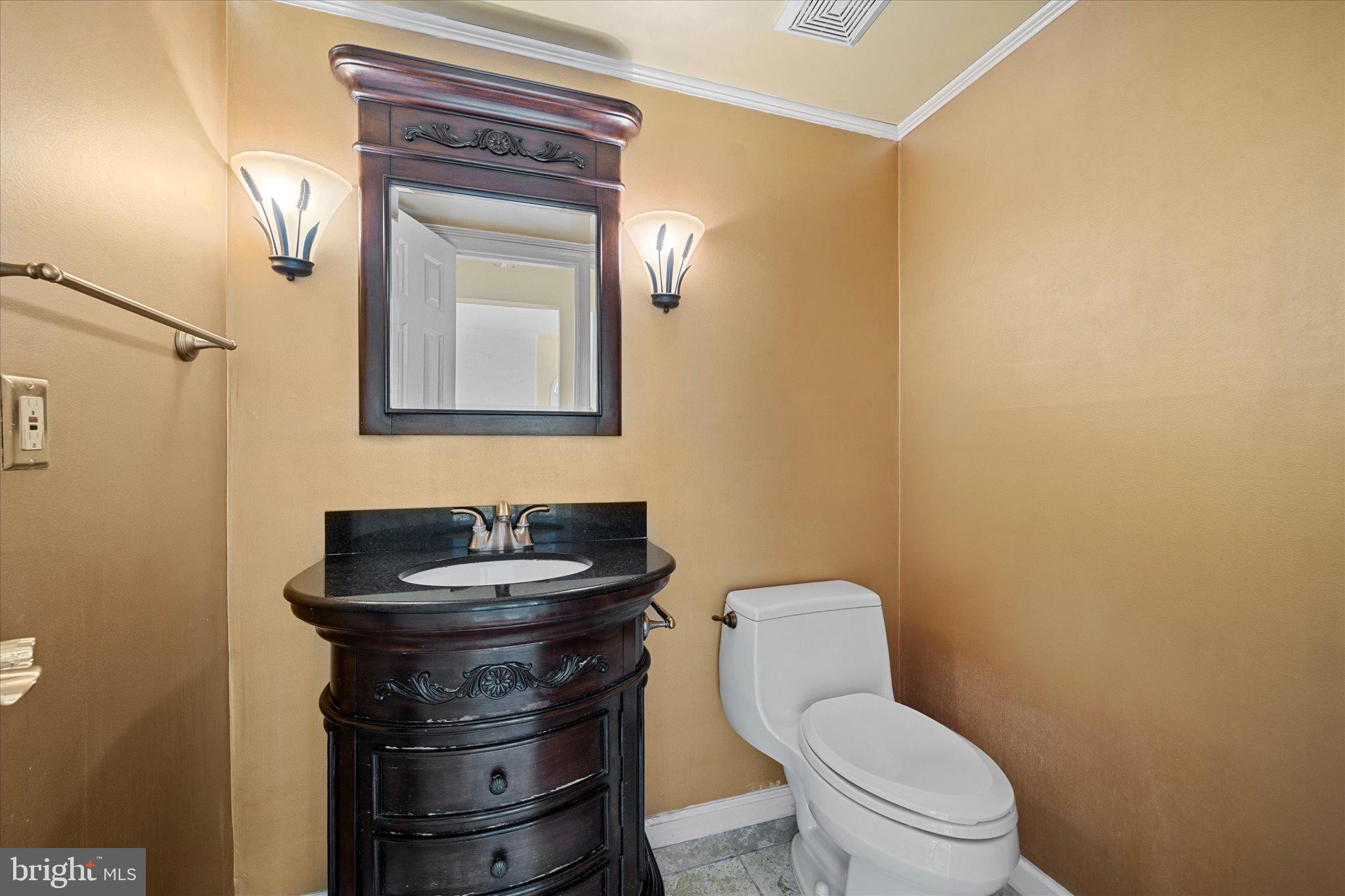 6832 Compton Heights Circle Clifton, VA 20124 - Photo 22 of 54 a bathroom with a toilet sink and mirror
