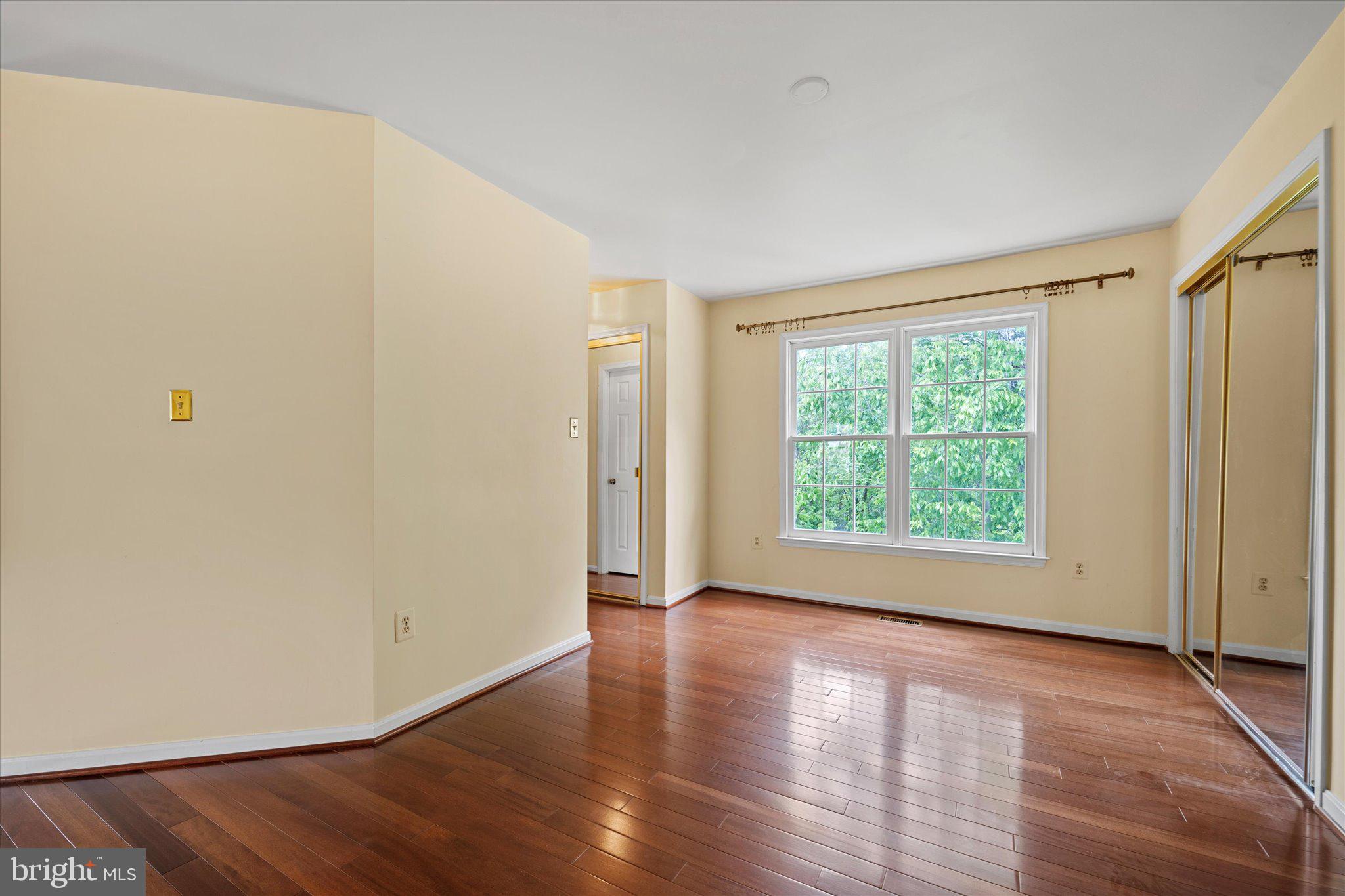 6832 Compton Heights Circle Clifton, VA 20124 - Photo 25 of 54 an empty room with wooden floor and windows