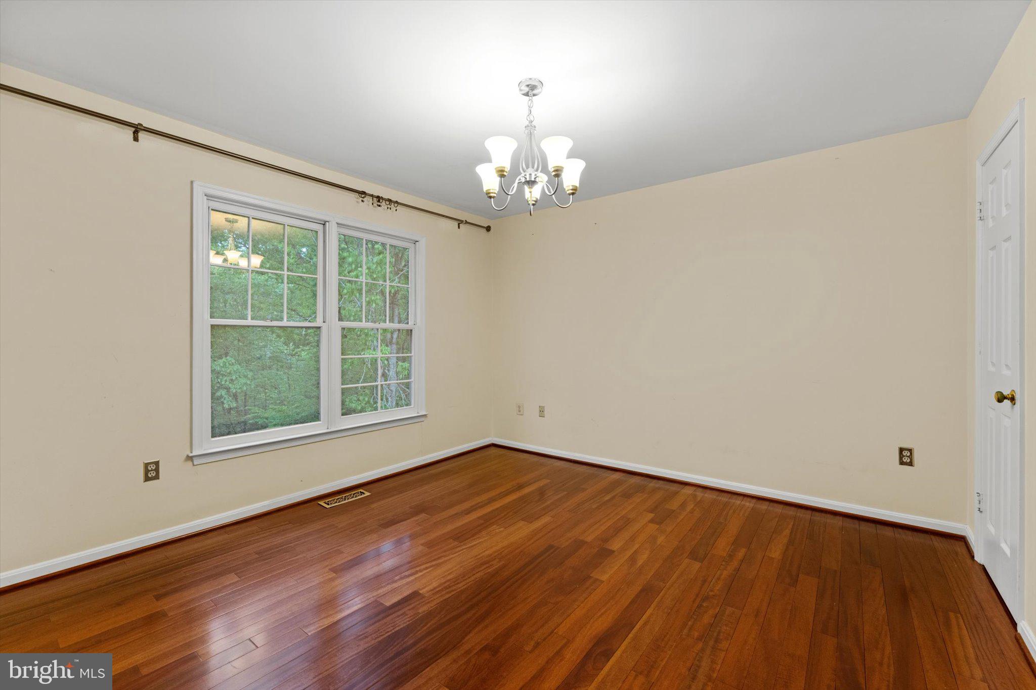 6832 Compton Heights Circle Clifton, VA 20124 - Photo 33 of 54 a view of an empty room with wooden floor and a window