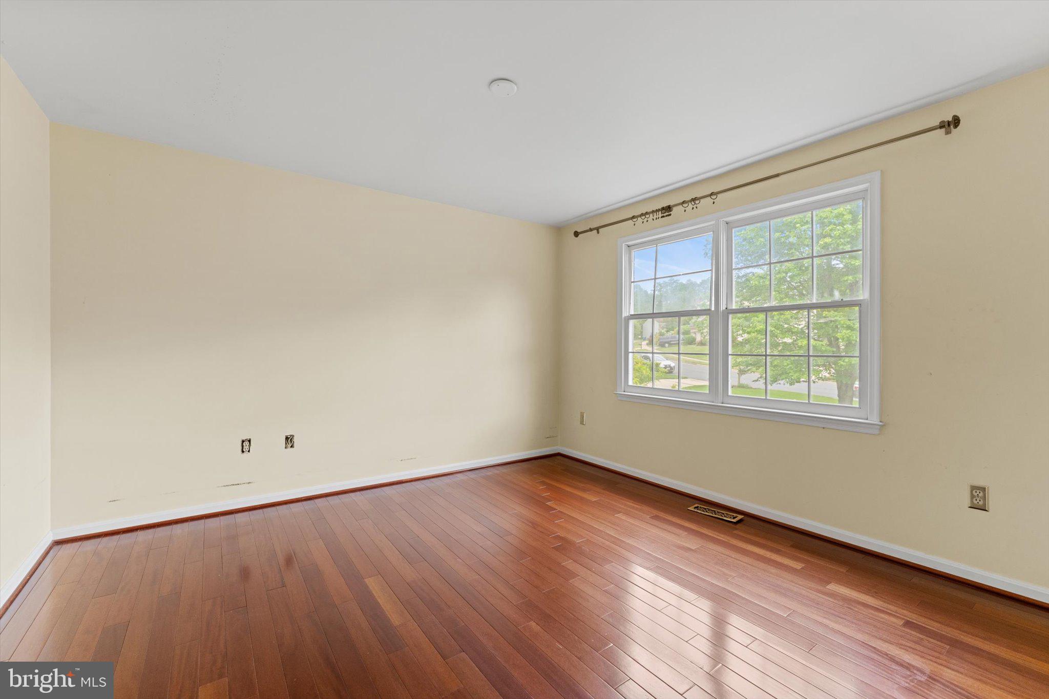 6832 Compton Heights Circle Clifton, VA 20124 - Photo 35 of 54 an empty room with wooden floor and windows