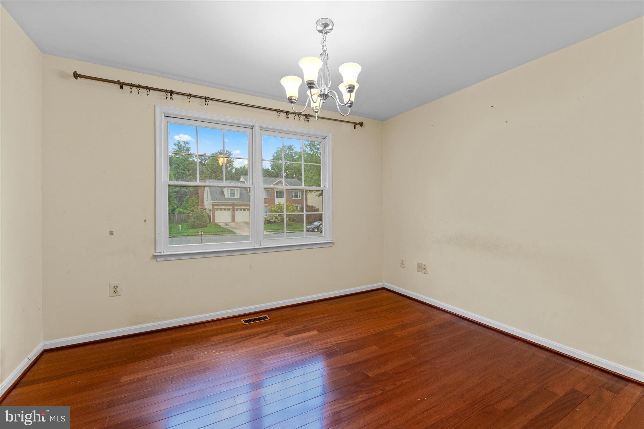 6832 Compton Heights Circle Clifton, VA 20124 - Photo 38 of 54 a big room with wooden floor a chandelier fan and windows