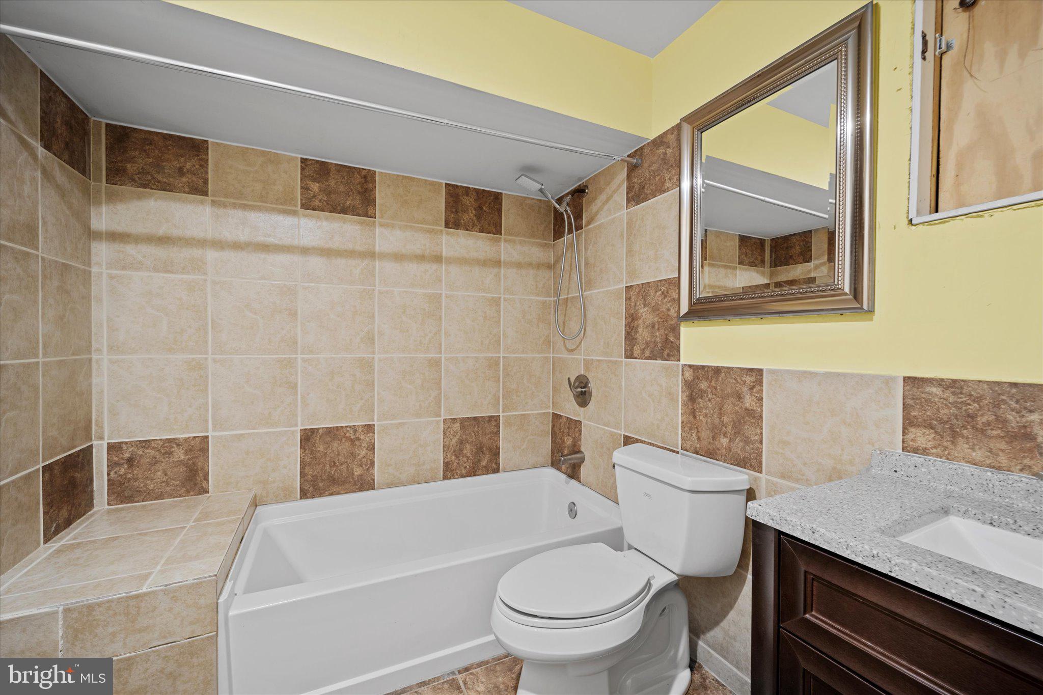 6832 Compton Heights Circle Clifton, VA 20124 - Photo 50 of 54 a bathroom with a granite countertop bathtub sink vanity mirror and toilet