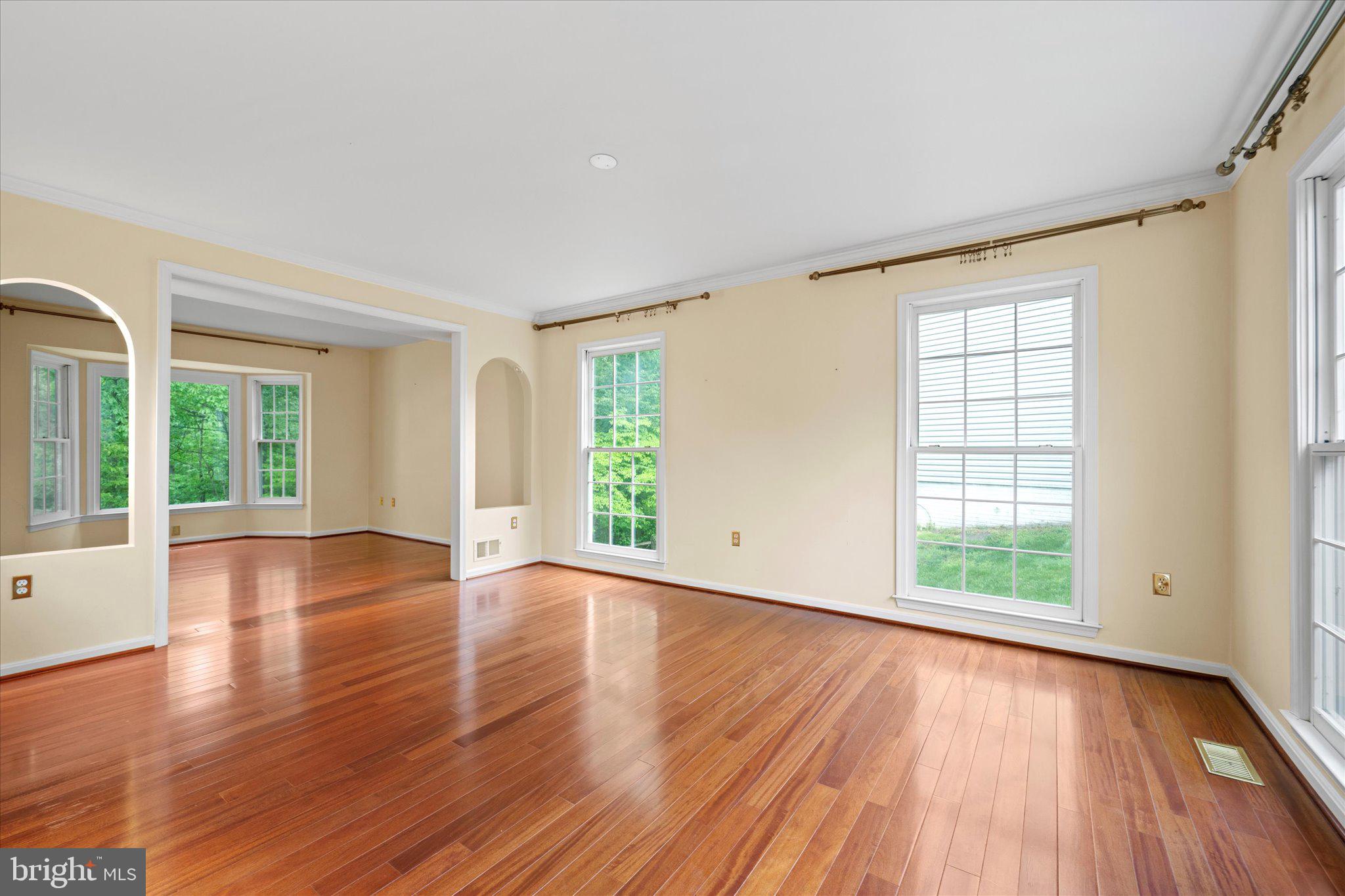 6832 Compton Heights Circle Clifton, VA 20124 - Photo 7 of 54 a view of an empty room with wooden floor and a window