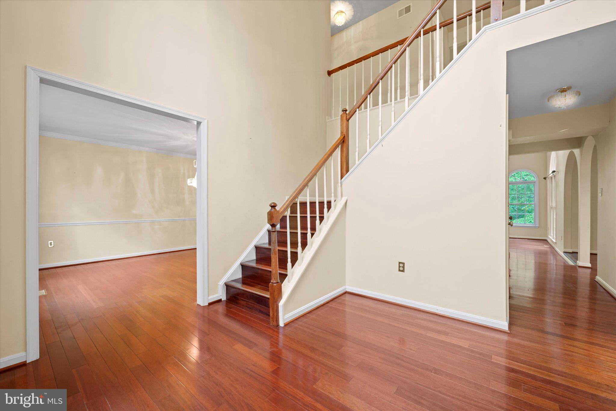 6832 Compton Heights Circle Clifton, VA 20124 - Photo 8 of 54 a view of staircase with wooden floor and white walls
