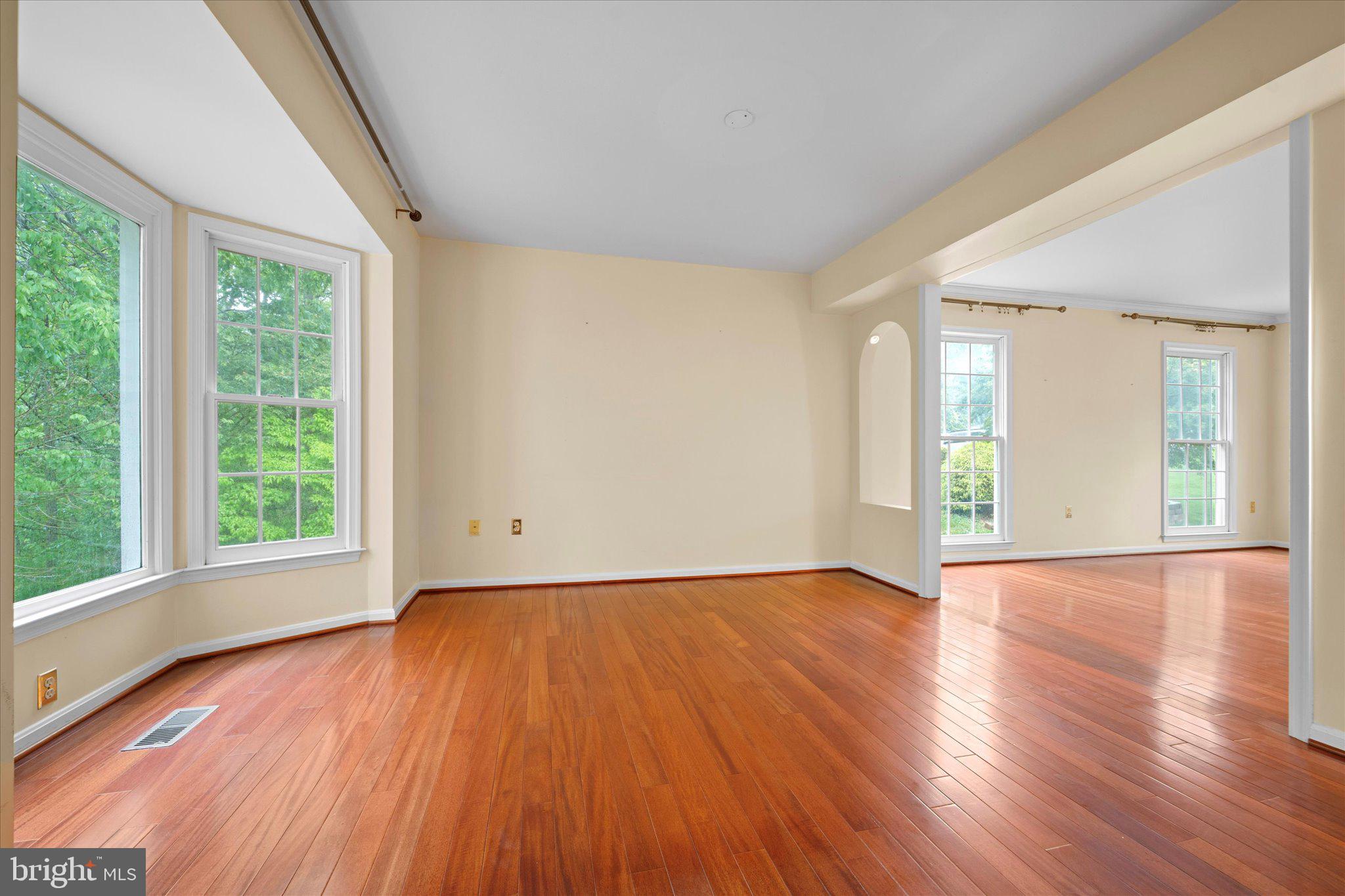 6832 Compton Heights Circle Clifton, VA 20124 - Photo 10 of 54 a view of an empty room with wooden floor and a window